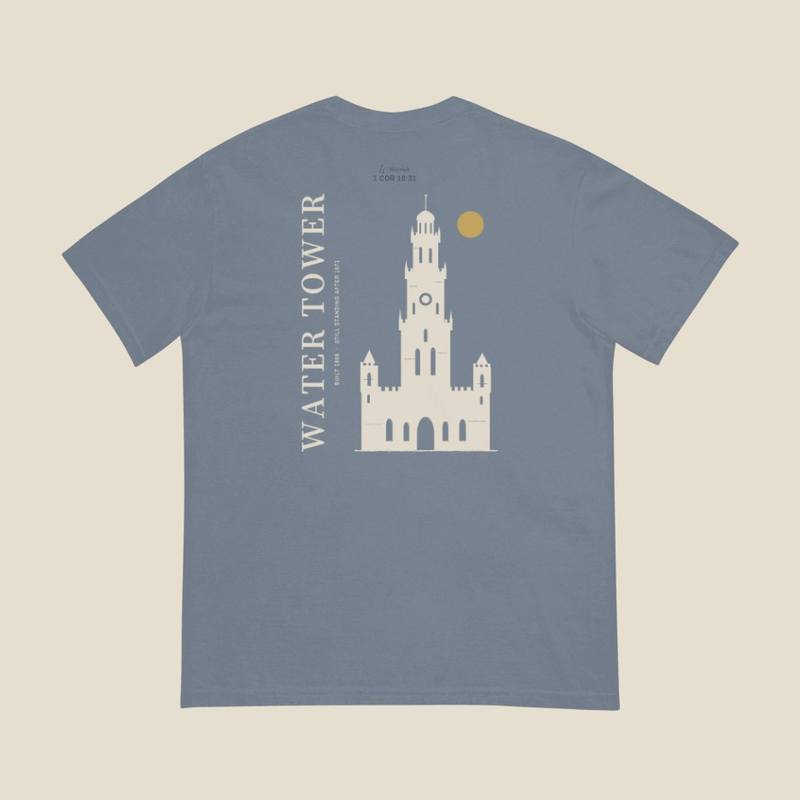 Chicago Water Tower Tee, back, Blue Jean: the mark and 1 COR 10:31 small at the neck, the tall tower in cream and a gold sun, WATER TOWER and BUILT 1869 · STILL STANDING AFTER 1871 up the left side