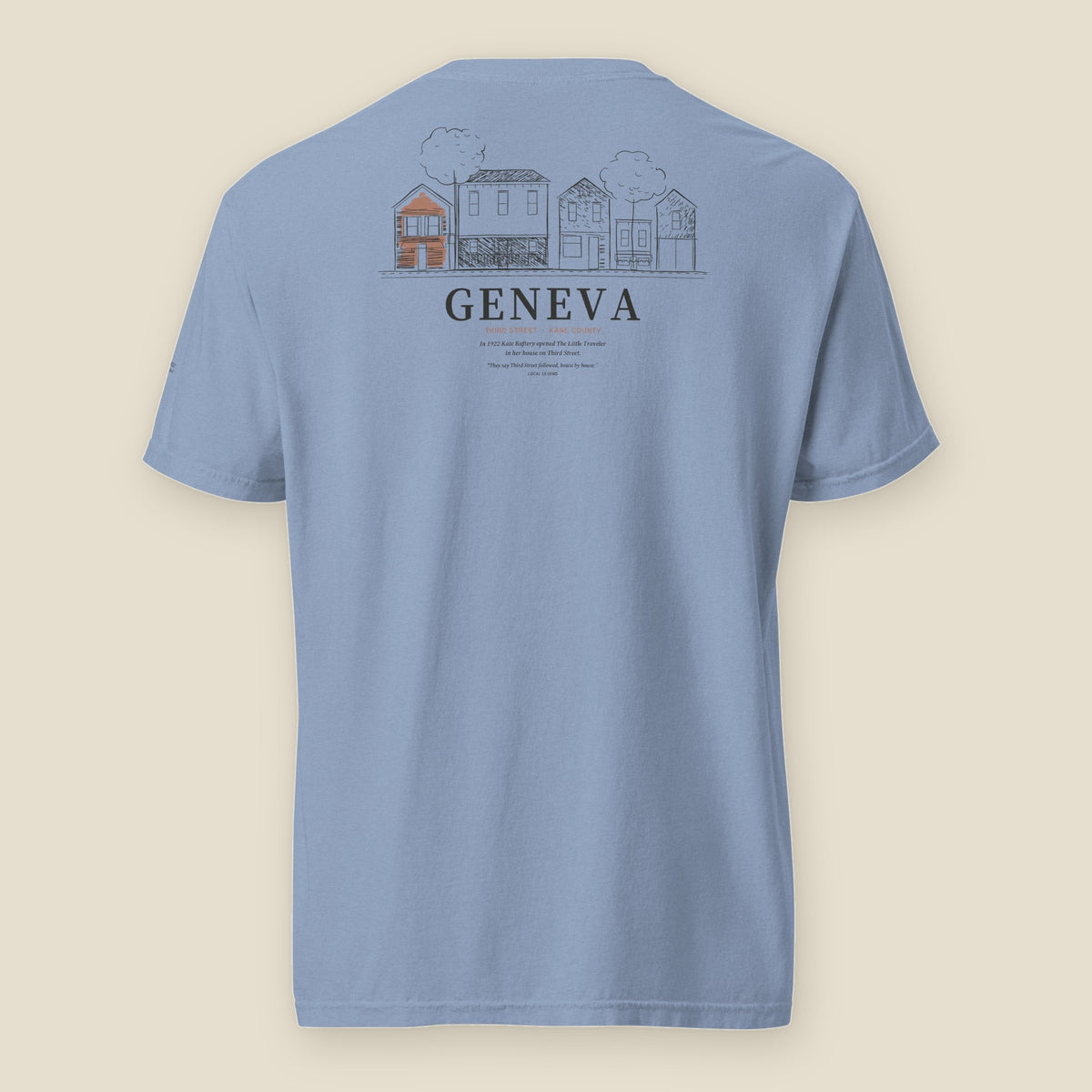 Geneva Tee, back, Washed Denim: a row of five Third Street house-shops, one red, over GENEVA and the story