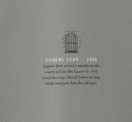 Woodstock Crewneck, left sleeve close-up, Grey: a barred cell window over EUGENE DEBS · 1895 and the story
