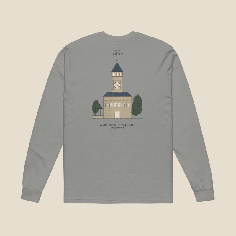 Woodstock Groundhog Day Long Sleeve, back, Lake Effect (Grey): the mark and 1 COR 10:31 small at the neck over the Woodstock Opera House between two trees, WOODSTOCK SQUARE below