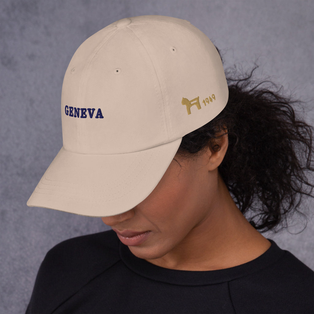 Geneva Hat, three-quarter left, worn, Stone: GENEVA in navy, the Dala horse and 1949 in Old Gold
