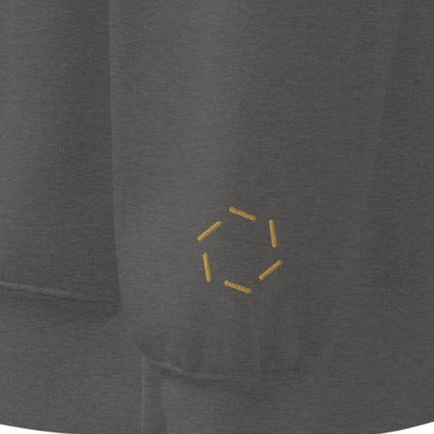 Crewneck, wrist close-up, Pepper: the six counties ring stitched in Old Gold at the left wrist.