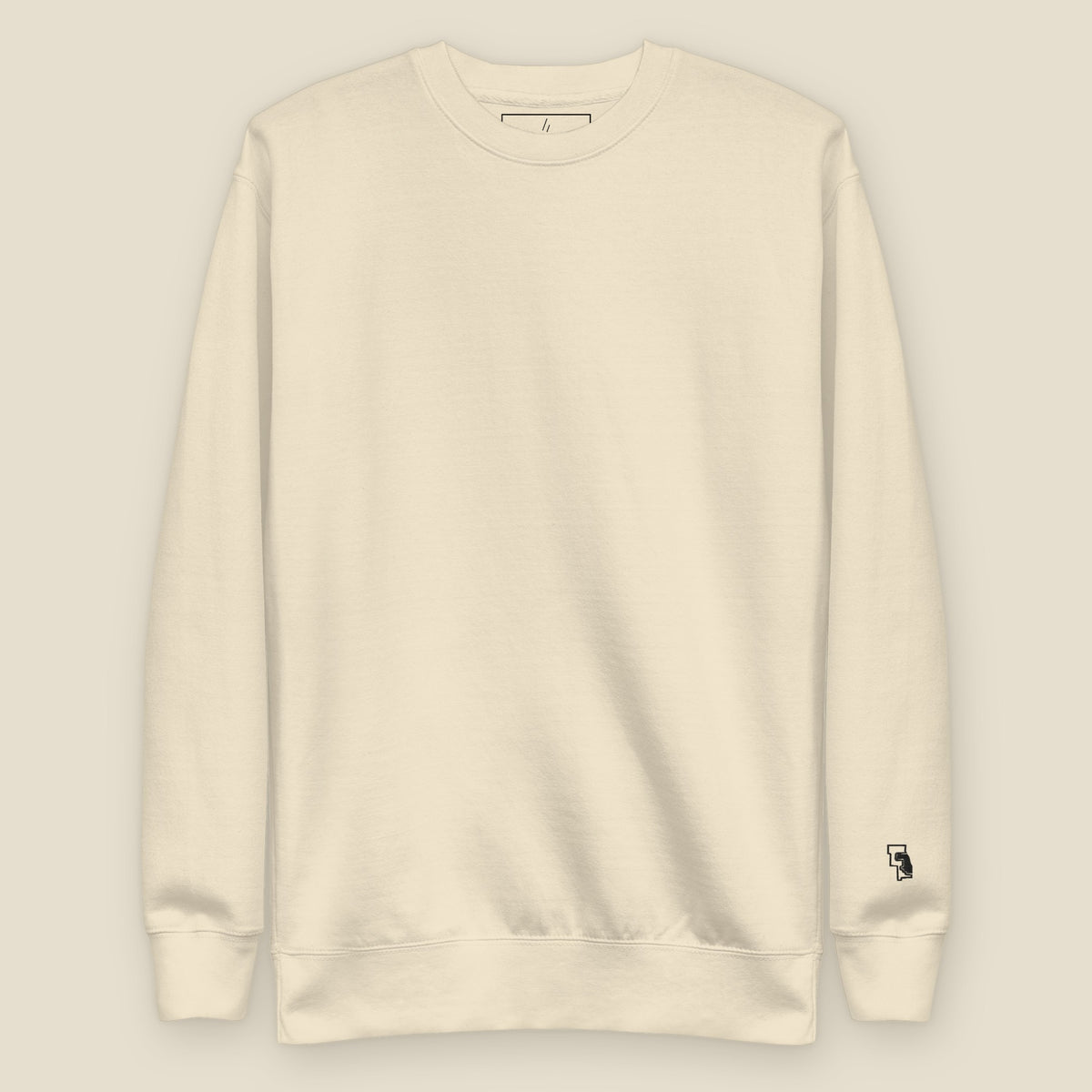 Green River Crewneck, front, Bone: plain front, the six-county mark stitched small at the left wrist.