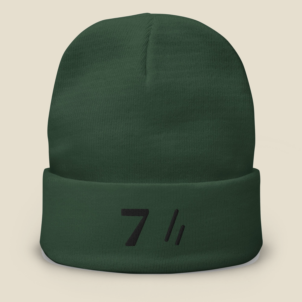 Mayvick Knit Beanie 7, front, Dark Green: a bold 7 and the double slanted line mark stitched on the cuff.