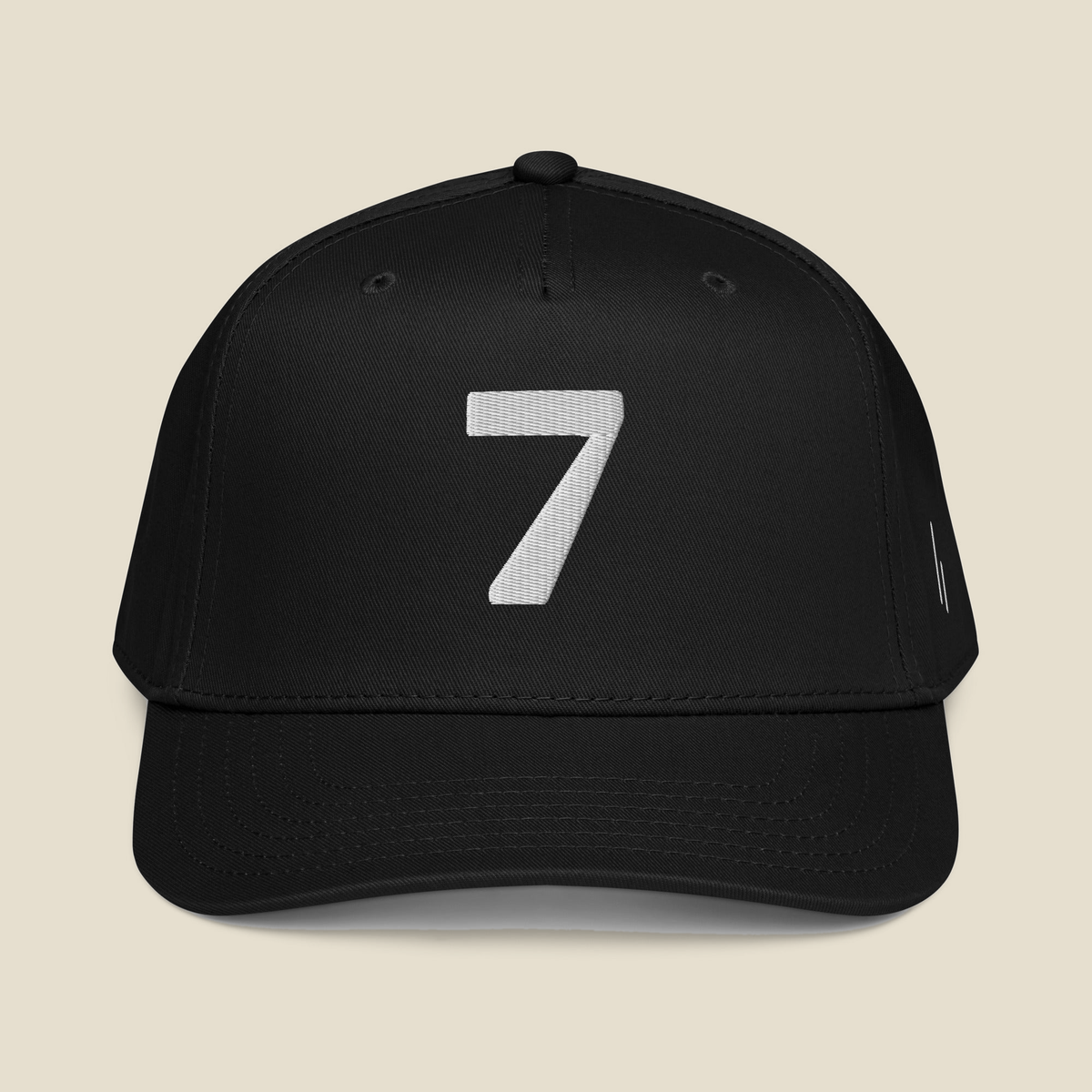 Mayvick Structured Cap 7, front, black: a bold 7 in white puff embroidery.