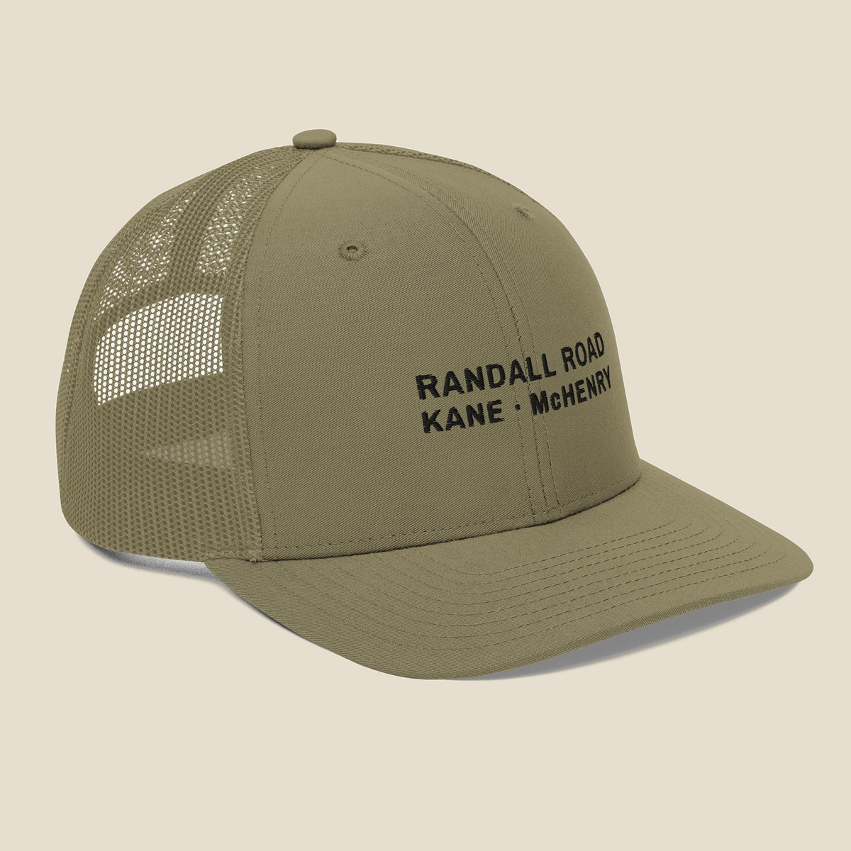 Randall Road Trucker Cap, three-quarter right, Light Olive: the front lettering and the mesh side.