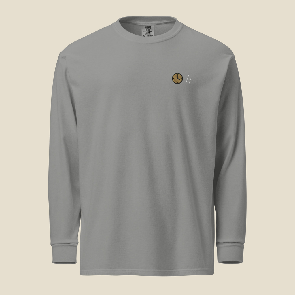 The Square Long Sleeve, front, Lake Effect (Grey): a stitched clock and the double slanted line mark.