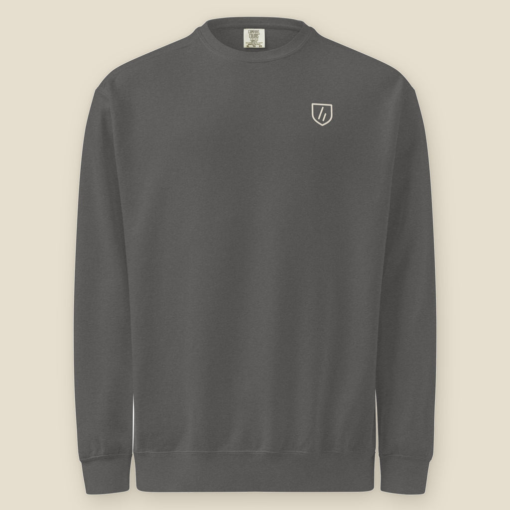 Joliet Crewneck, front: the double slanted line mark inside a small cream shield