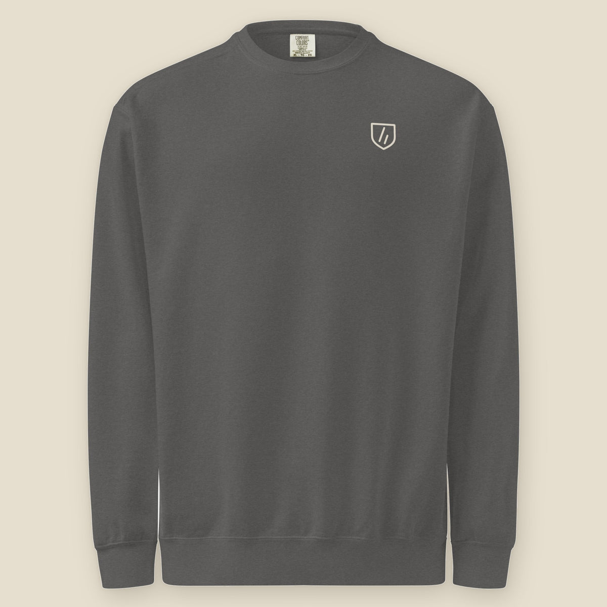 Joliet Crewneck, front: the double slanted line mark inside a small cream shield