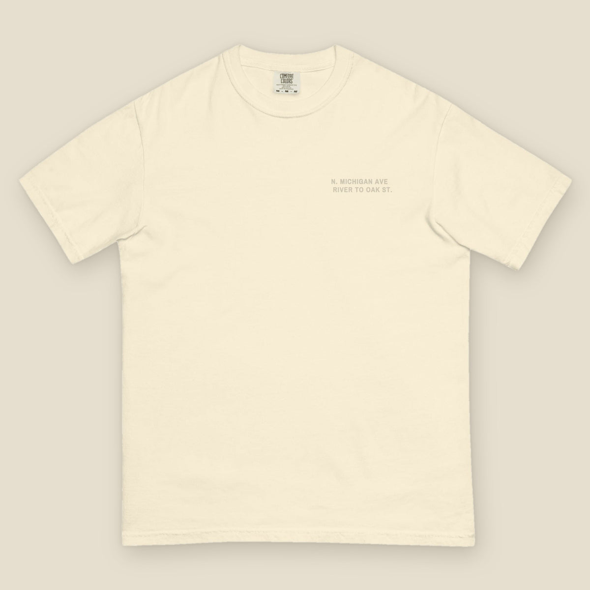 Magnificent Mile Tee, front, Lemont Stone (Ivory): N. MICHIGAN AVE / RIVER TO OAK ST. at the left chest.