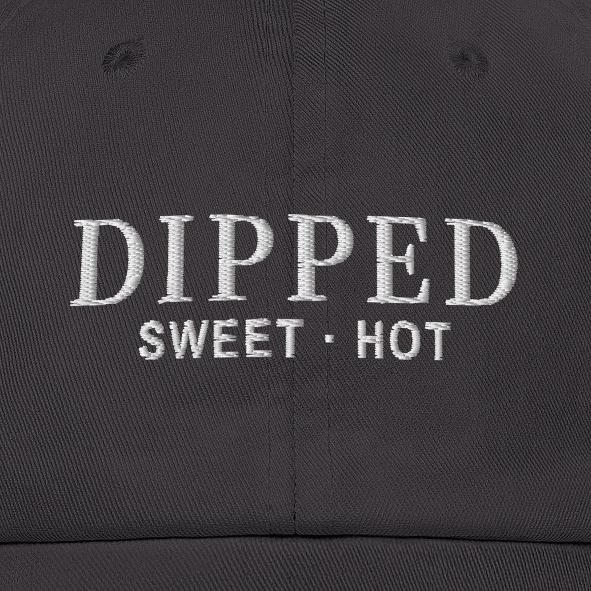 Dipped Dad Hat (Dark Grey), front close-up, Dark Grey: DIPPED over SWEET · HOT stitched in white.