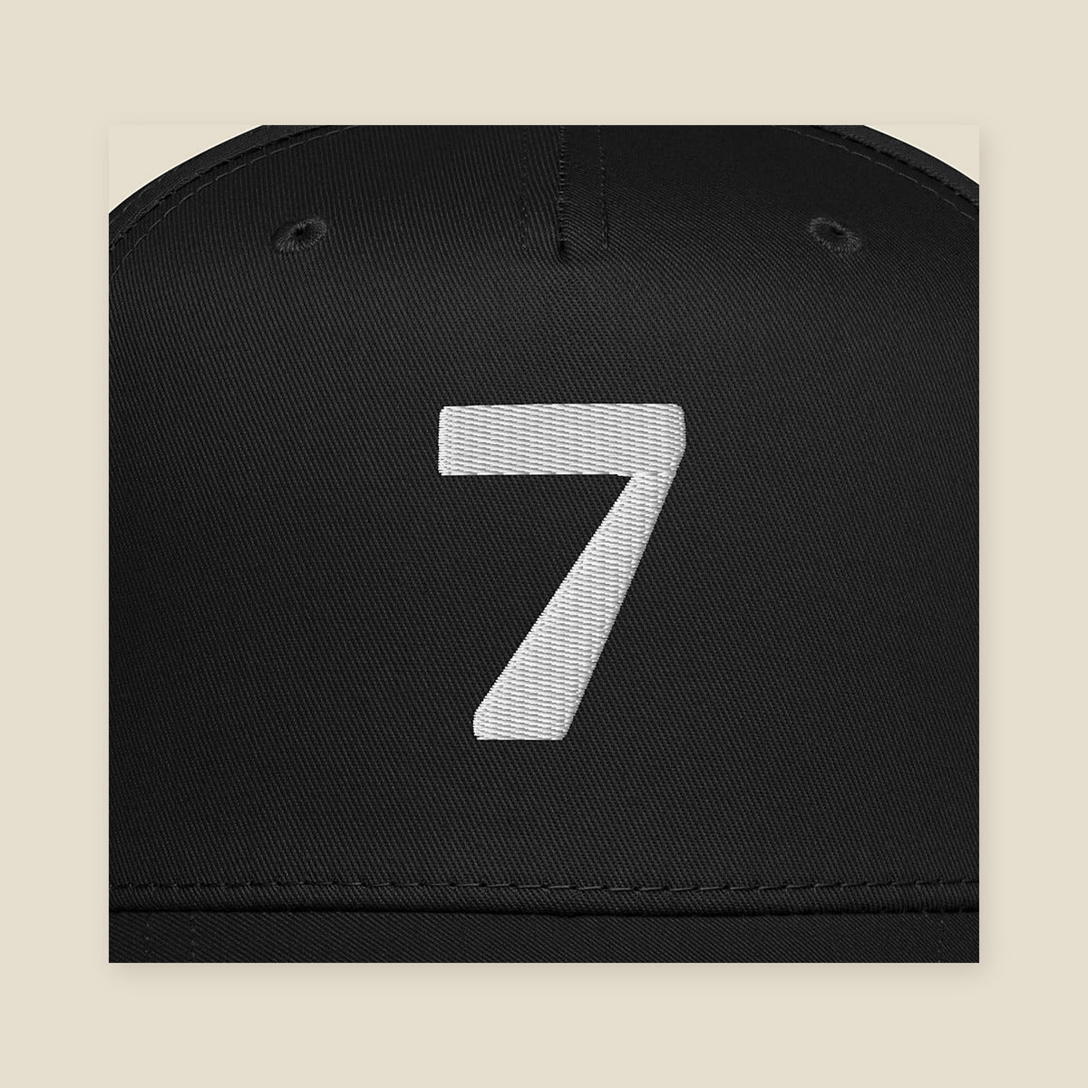 Mayvick Structured Cap 7, front close-up, Black: a bold 7 in white puff embroidery
