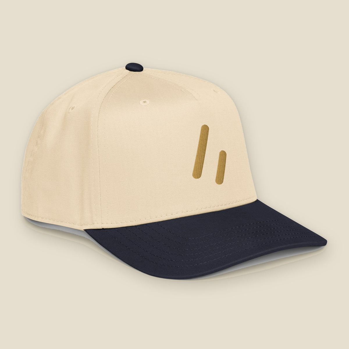 Mayvick Structured Cap, front-right, Natural/Navy: the Old Gold double slanted line mark on the crown.