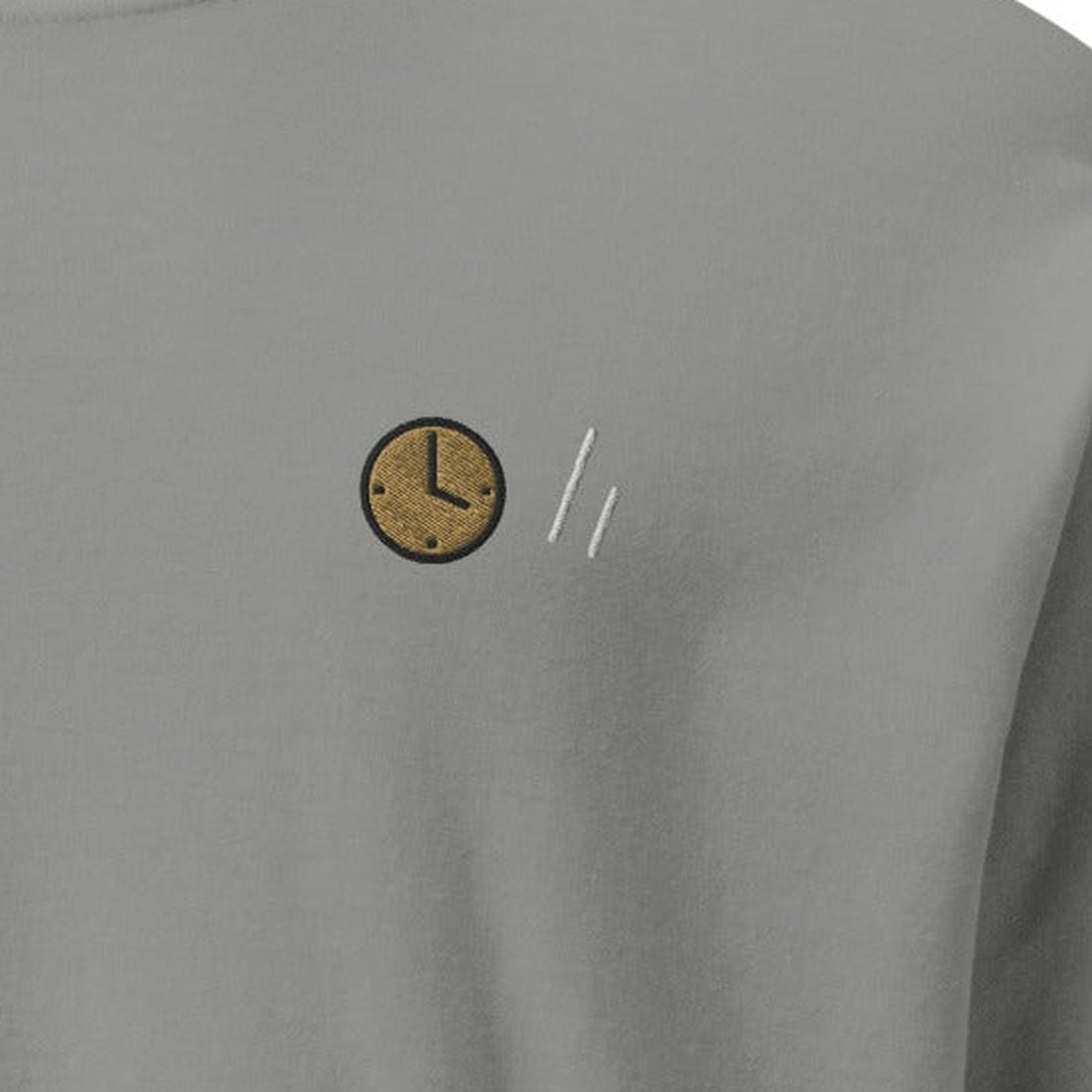 The Square Long Sleeve, chest close-up, Lake Effect (Grey): the clock and the double slanted line mark.