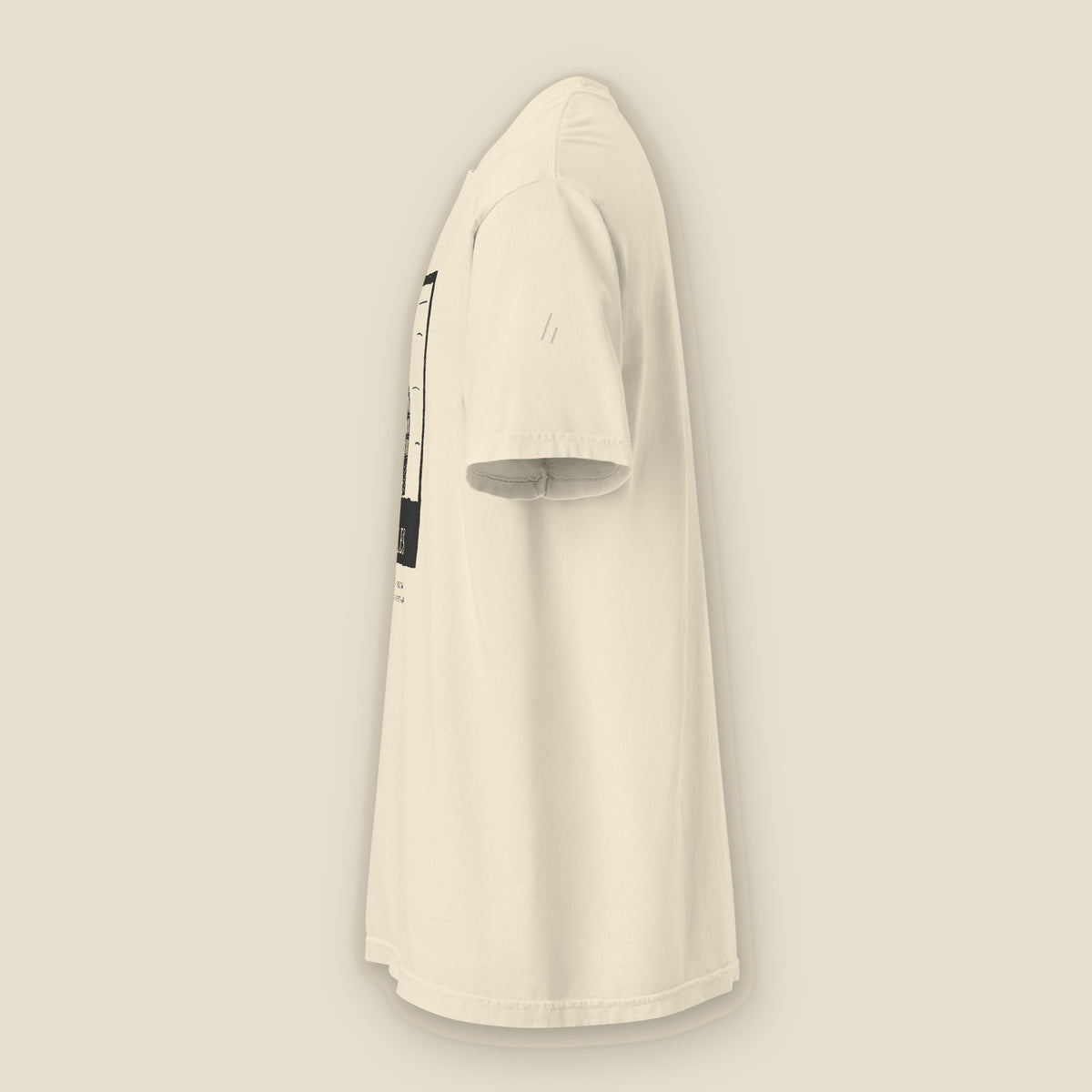 Niles Tee, left side, Lemont Stone (Ivory): the double slanted line mark printed tone on tone on the sleeve.