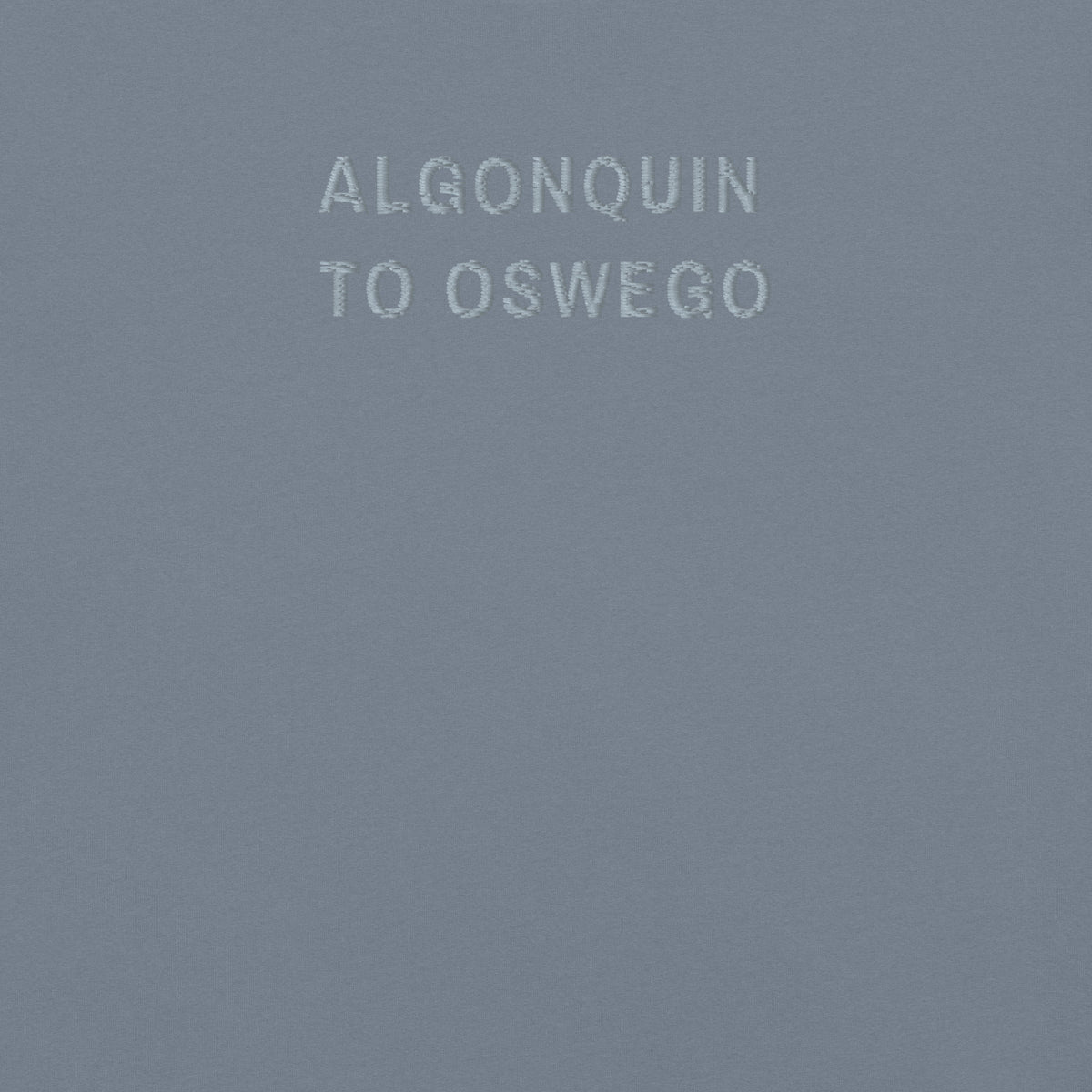 Fox River Trail Tee, chest close-up, Blue Jean: ALGONQUIN and TO OSWEGO stitched in grey thread.