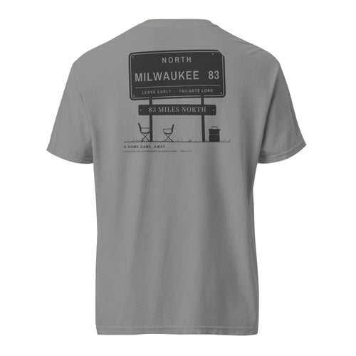 83 Miles North Tee, back, Grey: highway sign reading NORTH, MILWAUKEE 83 over two camp chairs and a cooler